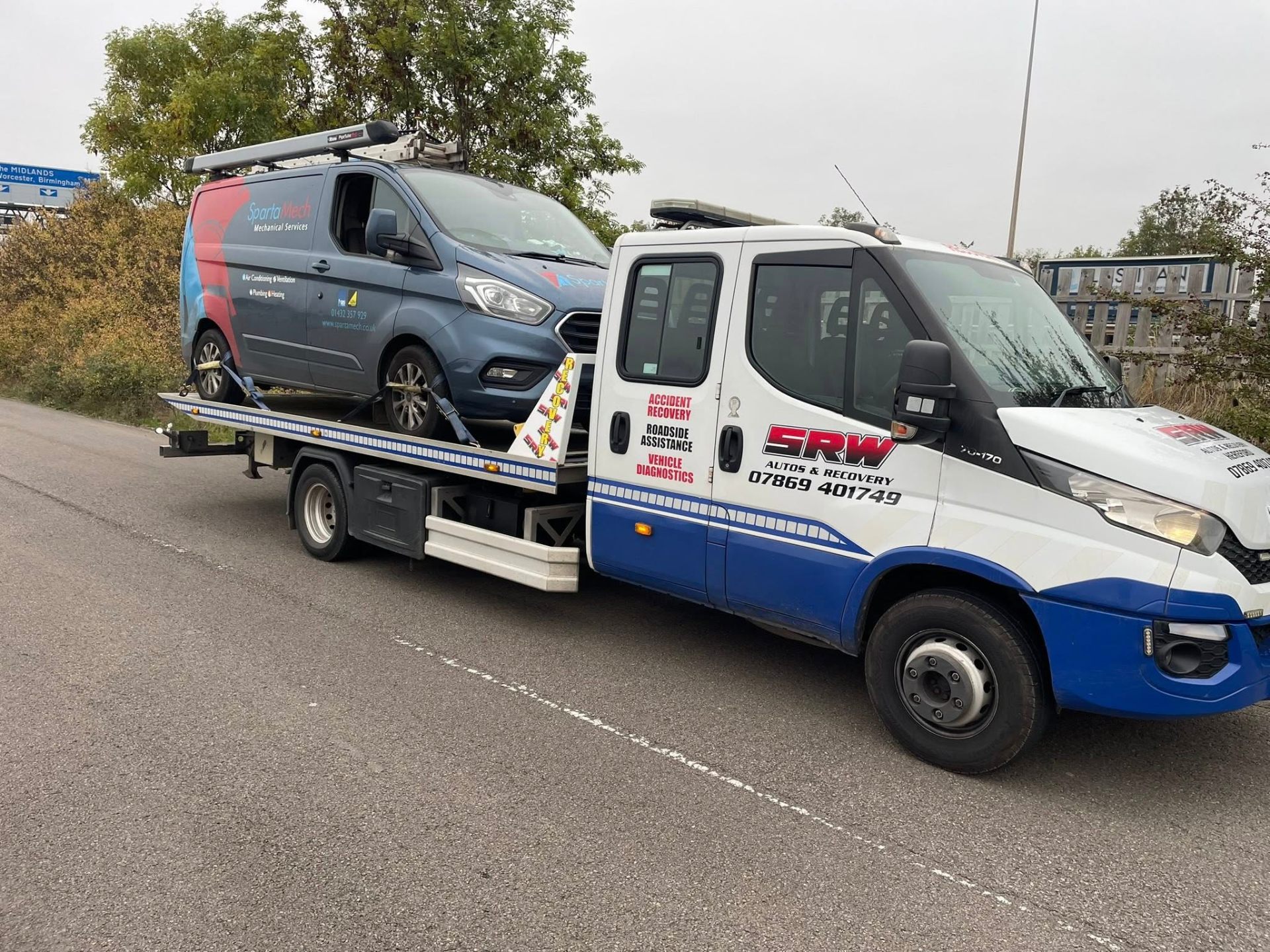 SRW recovery truck transporting a vehicle